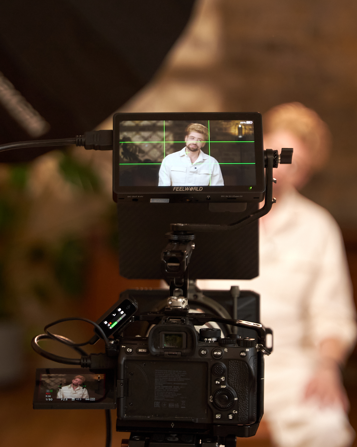 Behind-the-Scenes Photography - Filming High-Quality Video Content in Studio Behind-the-scenes view of a camera filming a speaker in a studio setup