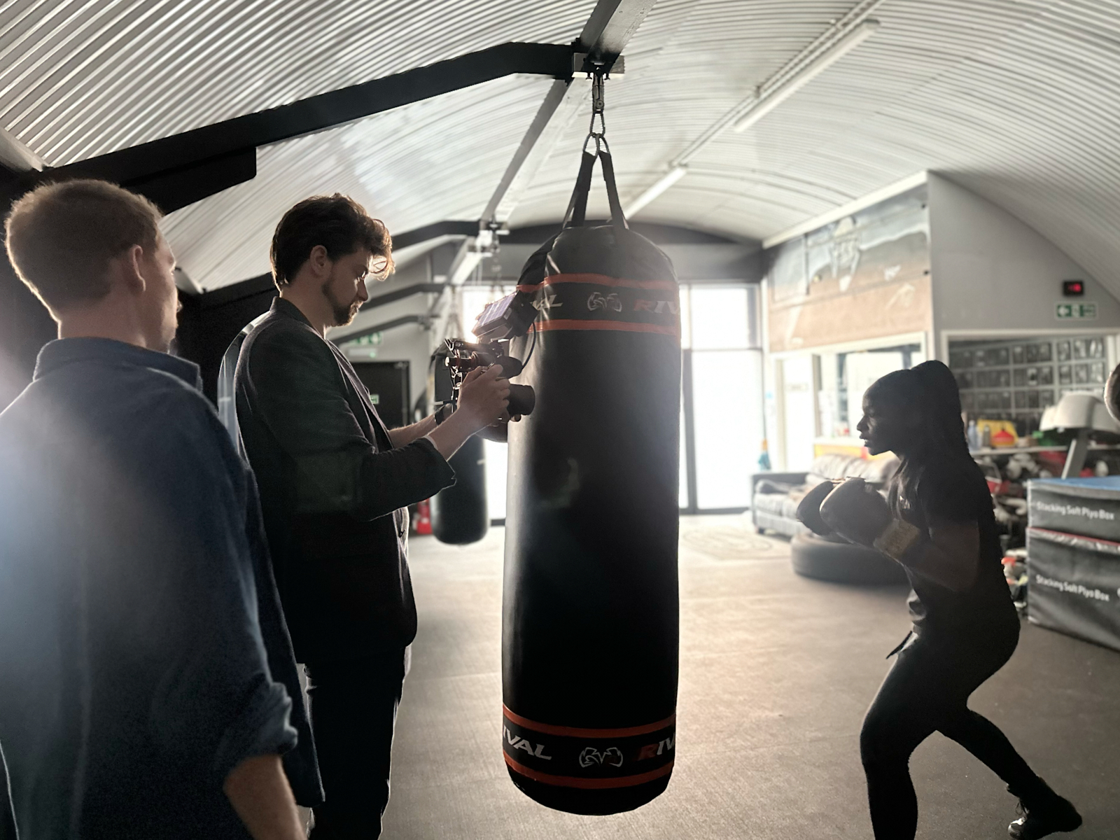 On-location Video Shoot - Capturing Training Moments for Authentic Brand Content Videographer filming a person training with a punching bag